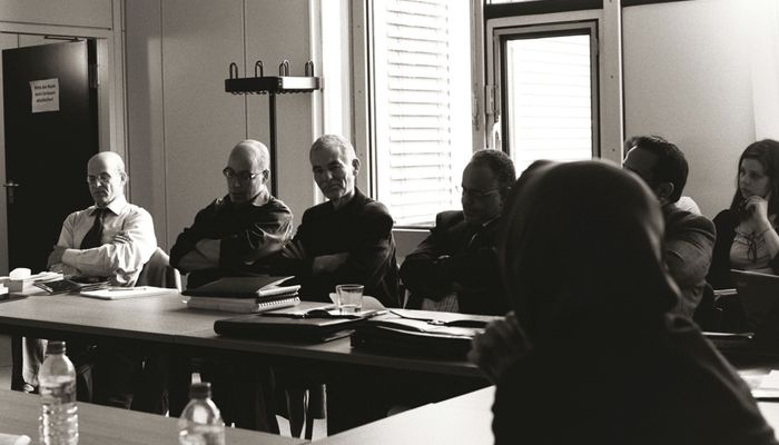 Group of people listening to a speaker.