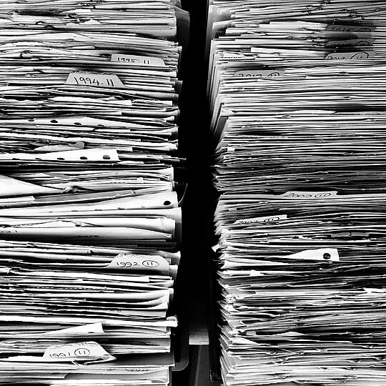 two piles of paper next to each other in black and white