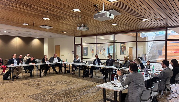 People sitting in a seminar room in a workshop setting.
