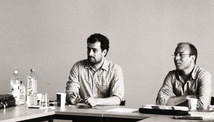 Two participants listening to a speaker.