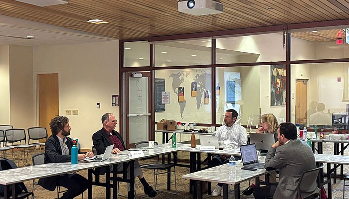 People sitting in a seminar room in a workshop setting.