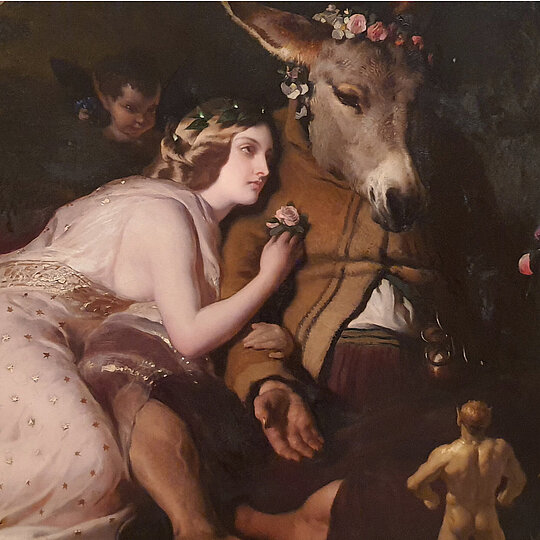 An oil painting of a woman in a flowing dress leaning on a man with a donkey head. The man is wearing a brown jacket and is surrounded by small fairy-like figures and rabbits in a dark forest setting.
