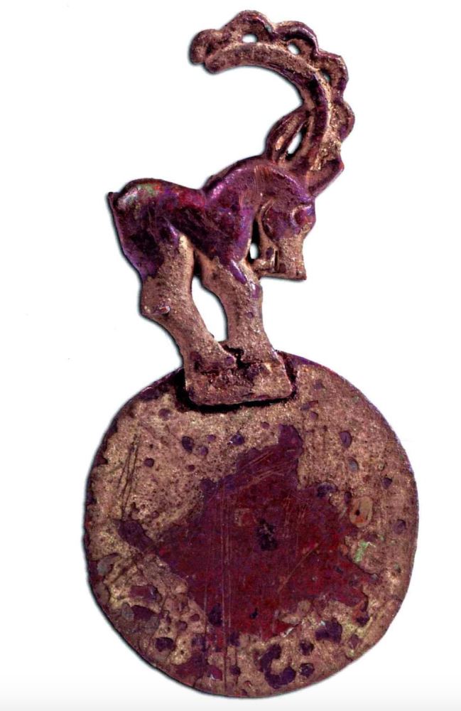 Mirror riveted with the handle of ibex, Yiwu county, Uygur Autonomous Region of Xinjiang, 5th – 3th c. BCE, 16 cm (H), 7.7 cm (D). Xinjiang Museum, Urumqi.