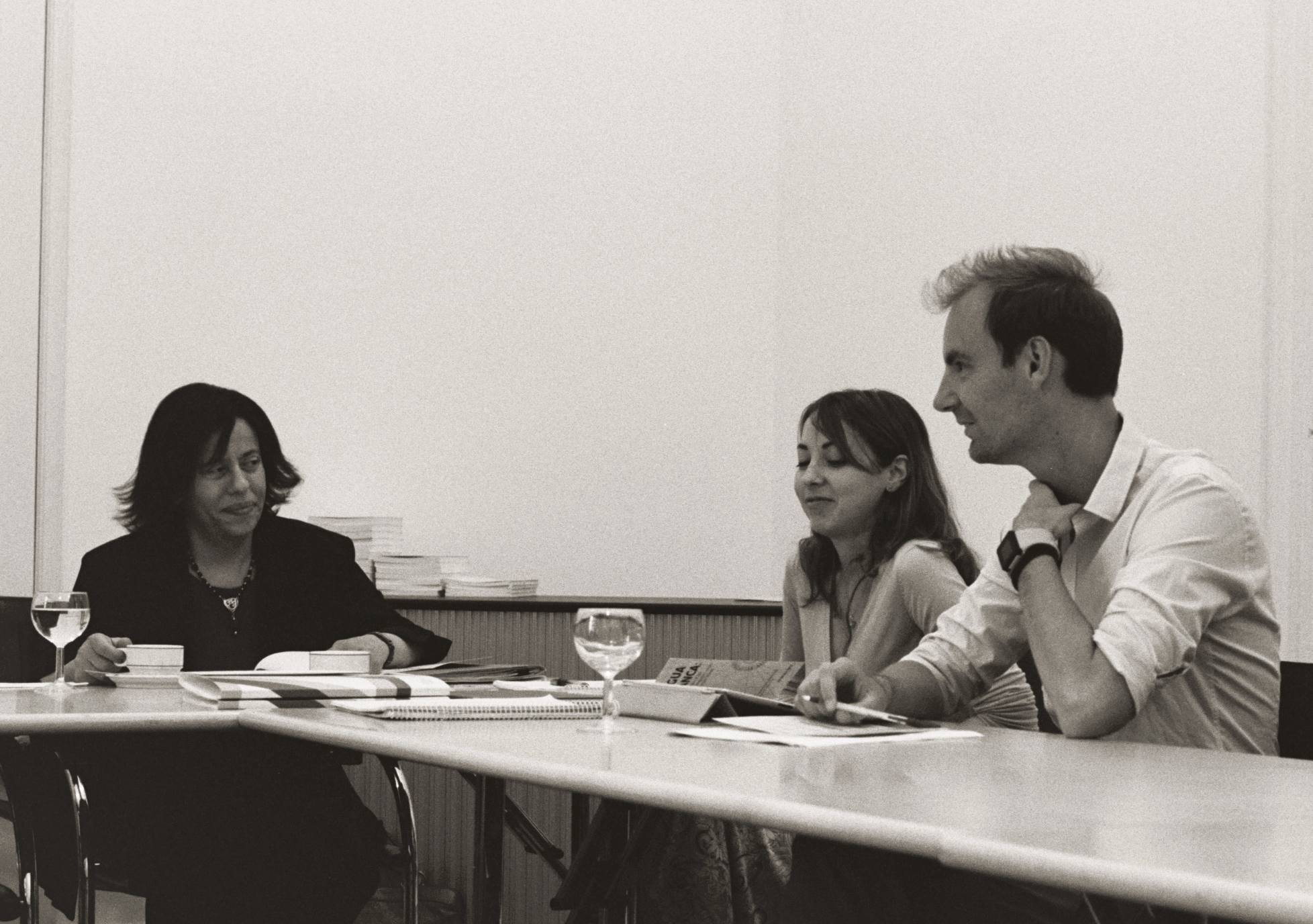 Three people sitting at a table.